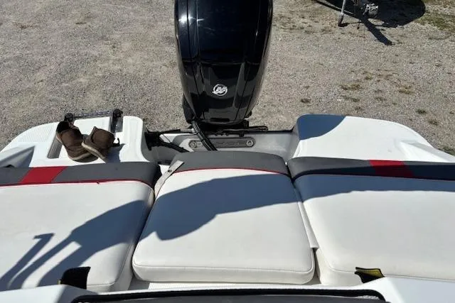 Slide: The Image of 2020 Tahoe T16 boat with white seating and outboard motor on gravel surface. - 70