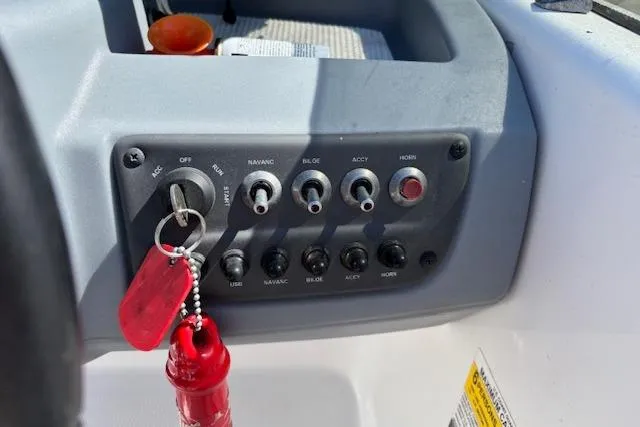 Slide: The Image of Control panel of a 2020 Tahoe T16 boat with ignition and switches. - 71