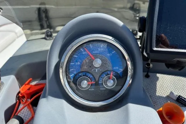 Slide: The Image of Dashboard of a 2020 Tahoe T16 boat with speedometer and gauges. - 72
