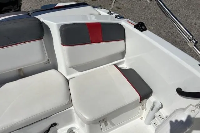 Slide: The Image of 2020 Tahoe T16 boat interior with white and gray seating, red accents. - 77