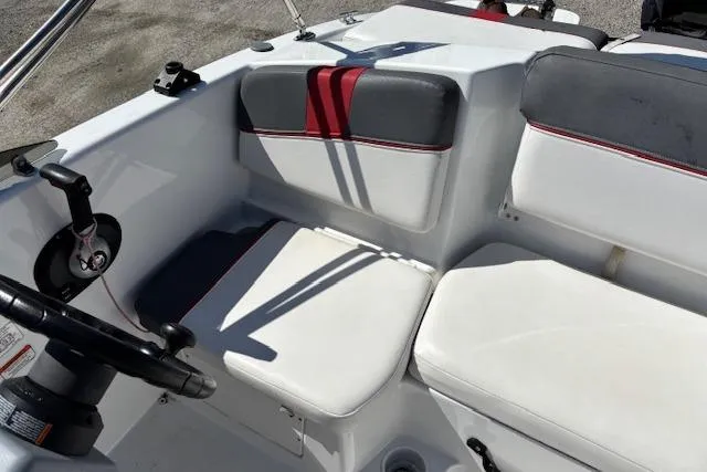 Slide: The Image of 2020 Tahoe T16 boat interior with white and gray seating, red accents, and steering wheel. - 78