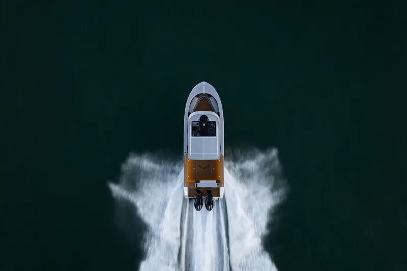 Slide: The Image of Aerial view of 2026 Jasper Marine Defender 22 boat on dark water. - 11