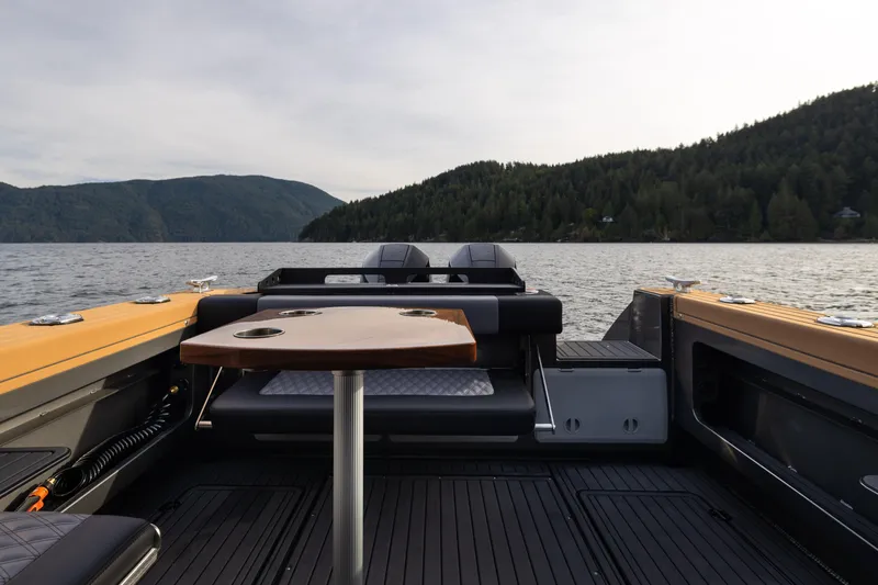 Slide: The Image of 2026 Jasper Marine Defender 22 boat interior with scenic lake and forest backdrop. - 25