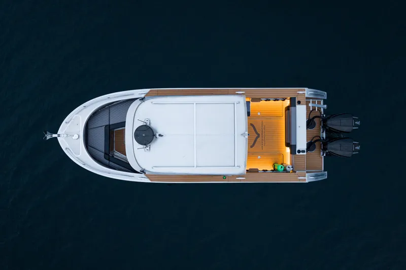 Slide: The Image of 2026 Jasper Marine Defender 22 boat with rooftop tent on serene lake. - 3