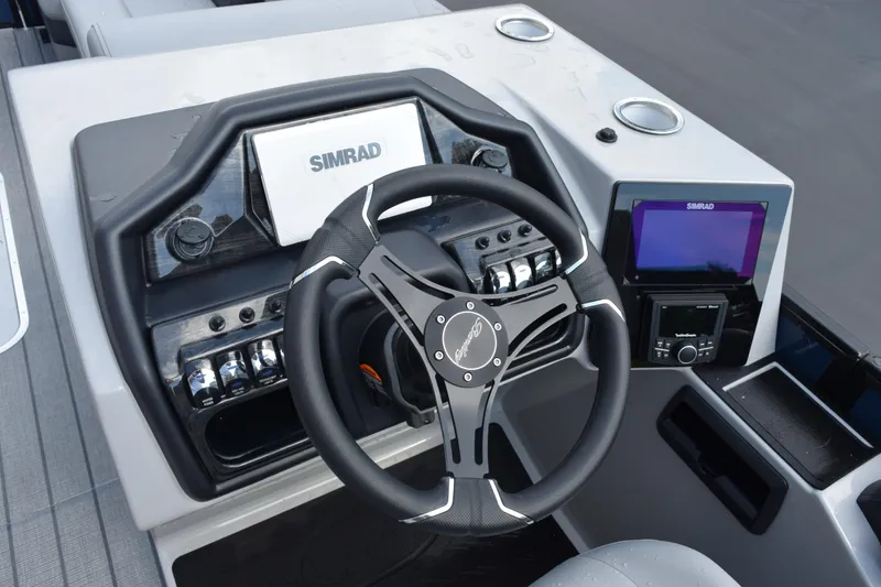 Slide: The Image of 2026 Bentley Pontoons Elite 253 Swingback dashboard with Simrad navigation system and steering wheel. - 12