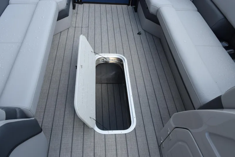 Slide: The Image of 2026 Bentley Pontoons Elite 253 Swingback interior with open storage compartment. - 16
