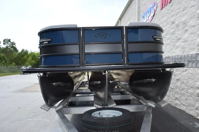 Slide: The Image of 2026 Bentley Pontoons Elite 253 Swingback on trailer, blue exterior, parked outdoors. - 3