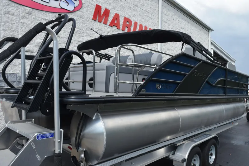 Slide: The Image of 2026 Bentley Pontoons Elite 253 Swingback on trailer outside marine dealership. - 4