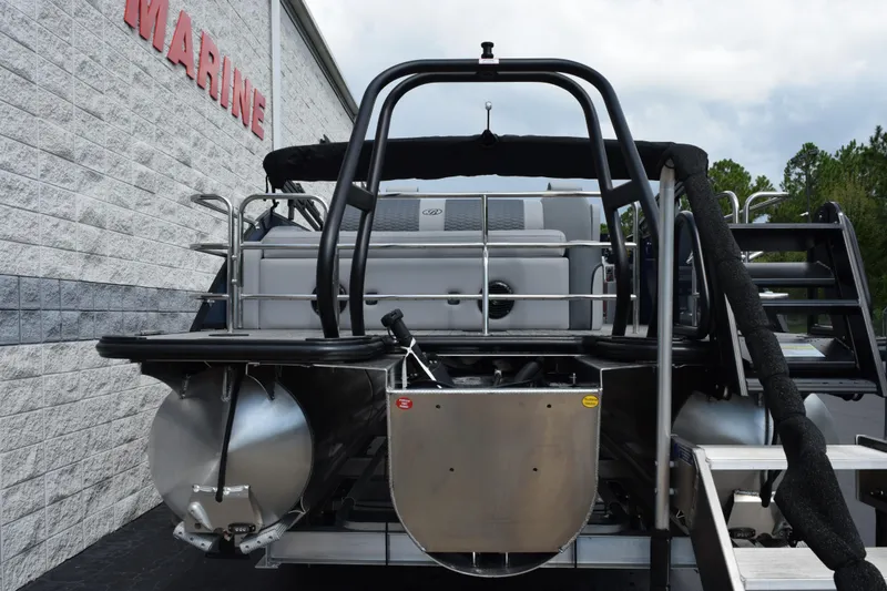 Slide: The Image of 2026 Bentley Pontoons Elite 253 Swingback, rear view at a marine dealership. - 5