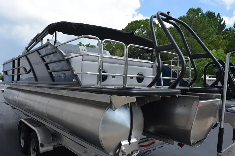 Slide: The Image of 2026 Bentley Pontoons Elite 253 Swingback on trailer, showcasing sleek design and sturdy construction. - 6
