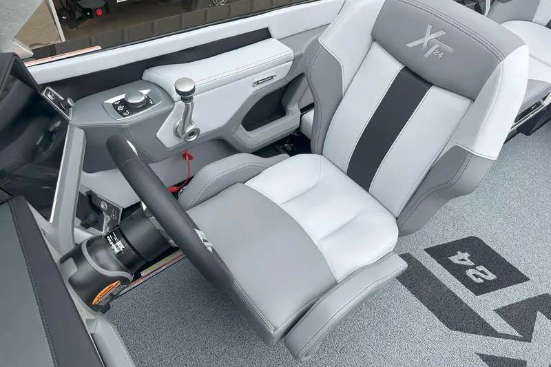 Slide: The Image of 2025 MasterCraft XT24 boat interior with sleek captain's chair and modern controls. - 3
