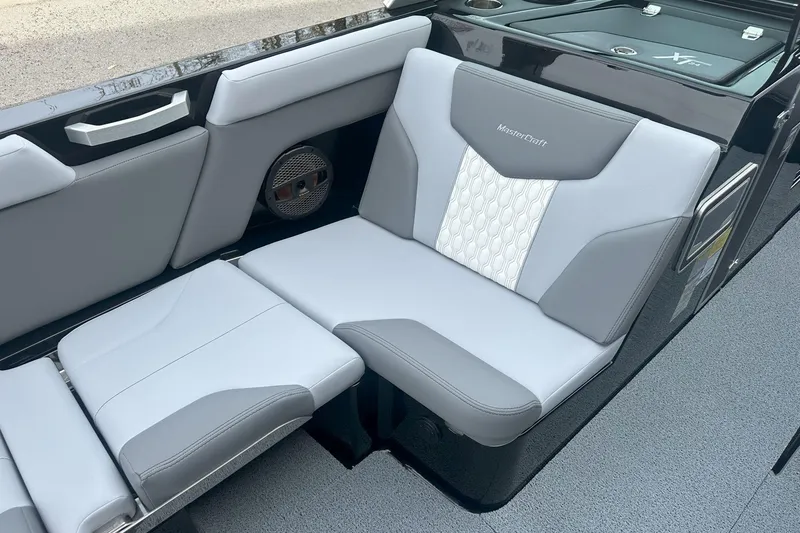 Slide: The Image of 2025 MasterCraft XT24 boat interior with gray and white cushioned seating. - 7