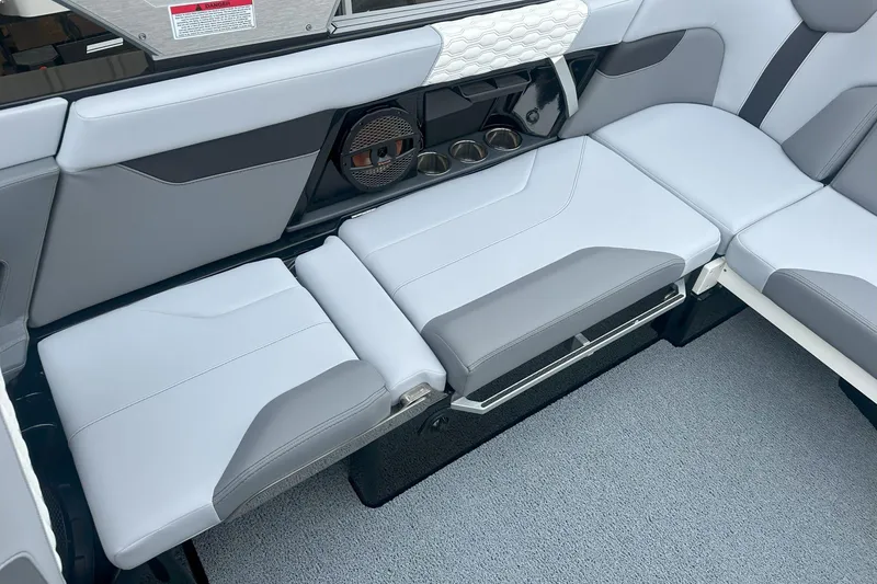 Slide: The Image of 2025 MasterCraft XT24 interior seating with sleek design and integrated speaker system. - 8