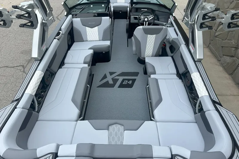 Slide: The Image of 2025 MasterCraft XT24 boat interior with gray and white seating, modern design. - 9