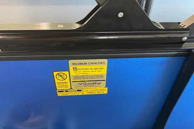 Slide: The Image of 2026 Bentley Pontoons Legacy 223 Swingback capacity label, blue background, 15-person limit. - 9