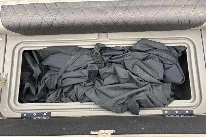 Slide: The Image of Storage compartment with fabric inside a 2021 Sun Tracker Party Barge 20 DLX. - 12