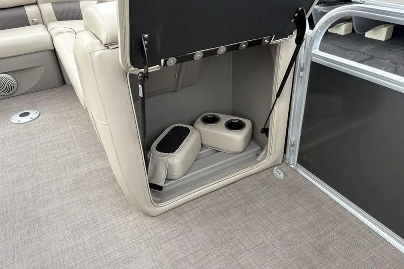Slide: The Image of 2021 Sun Tracker Party Barge 20 DLX interior storage with cup holders and seating. - 13