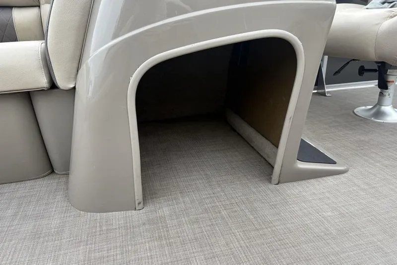 Slide: The Image of 2021 Sun Tracker Party Barge 20 DLX interior storage compartment with beige seating. - 15