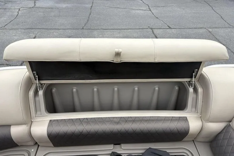 Slide: The Image of 2021 Sun Tracker Party Barge 20 DLX storage compartment with open seat cushion. - 16