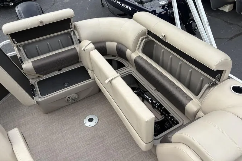 Slide: The Image of 2021 Sun Tracker Party Barge 20 DLX with open storage compartments and beige seating. - 23