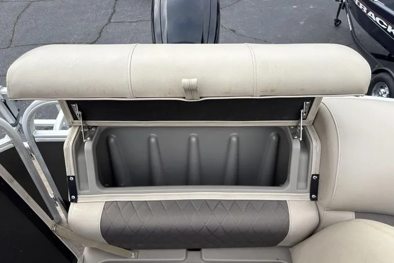 Slide: The Image of 2021 Sun Tracker Party Barge 20 DLX storage compartment with cushioned seat and diamond-patterned design. - 28