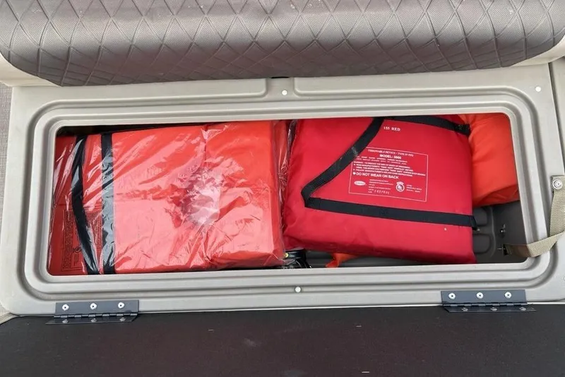Slide: The Image of Storage compartment with life jackets on a 2021 Sun Tracker Party Barge 20 DLX. - 5