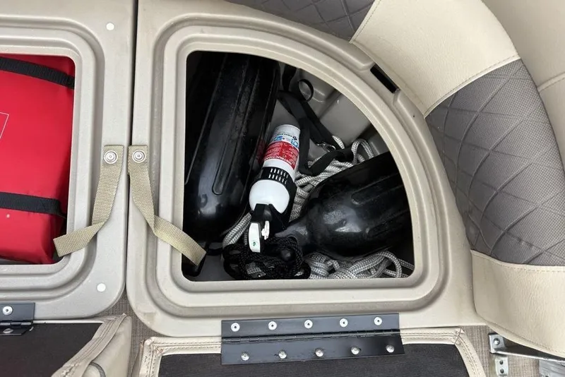 Slide: The Image of Storage compartment on 2021 Sun Tracker Party Barge 20 DLX with safety equipment. - 6