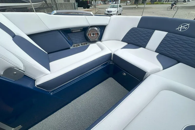 Slide: The Image of Luxurious seating in 2021 MasterCraft X24 boat, featuring blue and white upholstery. - 11