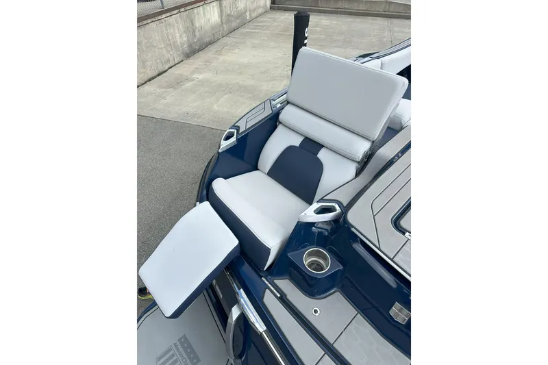 Slide: The Image of 2021 MasterCraft X24 boat with luxurious seating and cup holder on deck. - 13