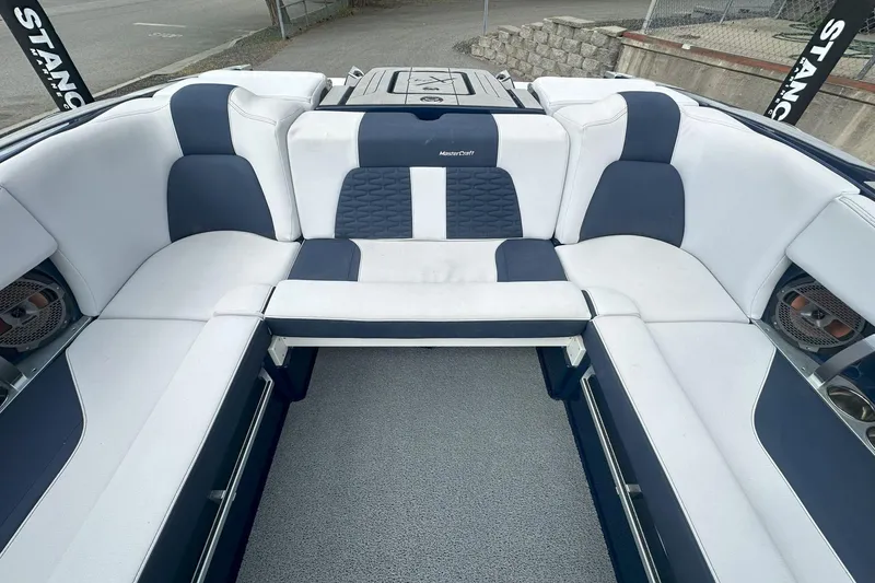 Slide: The Image of 2021 MasterCraft X24 boat interior with white and navy seating, showcasing luxury design. - 5