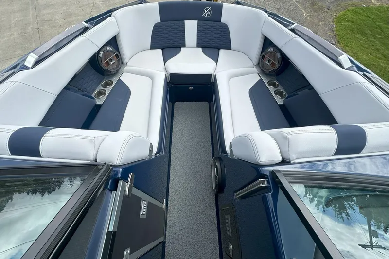 Slide: The Image of 2021 MasterCraft X24 boat interior with luxurious seating and cup holders. - 9