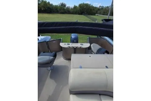 Slide: The Image of 2015 Manitou 20 Oasis Angler boat interior with seating and control panel. - 11