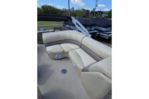 Slide: The Image of 2015 Manitou 20 Oasis Angler boat with beige seating and spacious deck area. - 12