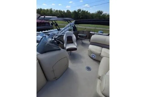 Slide: The Image of 2015 Manitou 20 Oasis Angler boat interior with seating and steering console. - 13