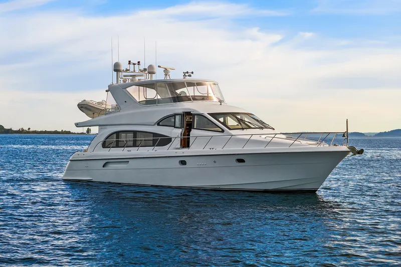 The Image of 2001 Hatteras 63 Cockpit Motor Yacht cruising on calm blue waters. - 0