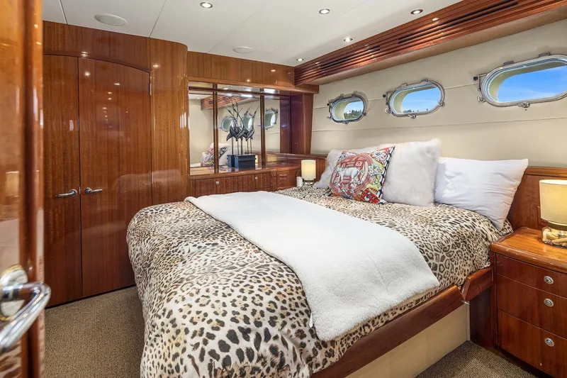 Slide: The Image of Luxurious bedroom interior of 2001 Hatteras 63 Cockpit Motor Yacht with elegant wood finishes. - 12