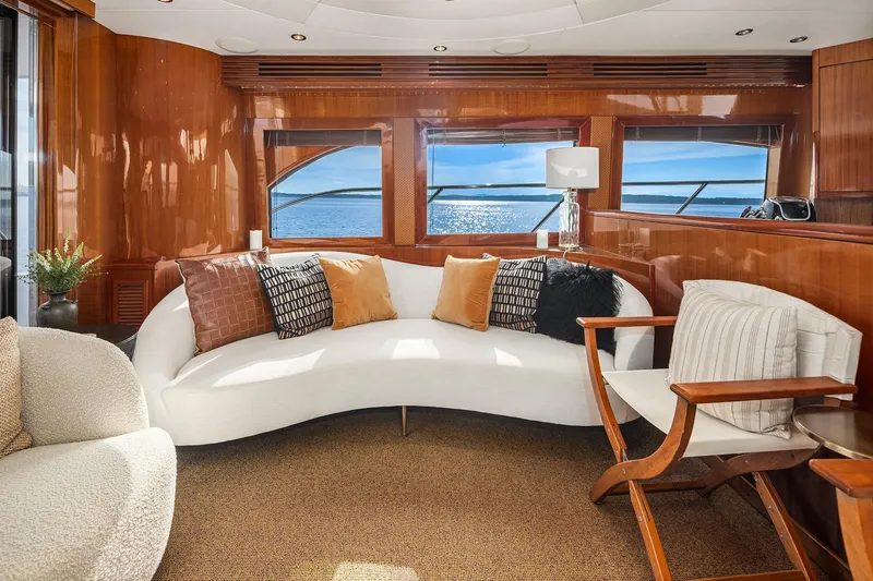 Slide: The Image of Luxurious interior of 2001 Hatteras 63 Cockpit Motor Yacht with ocean view and elegant wood finish. - 3