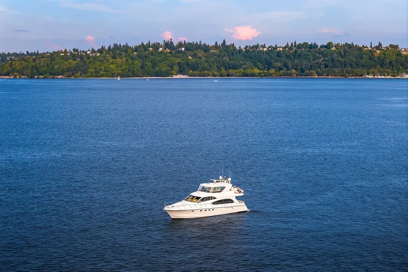 Slide: The Image of Aerial view of 2001 Hatteras 63 Cockpit Motor Yacht on blue ocean water. - 35