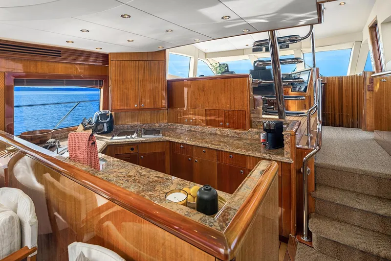 Slide: The Image of Luxurious kitchen interior of 2001 Hatteras 63 Cockpit Motor Yacht with ocean view. - 5