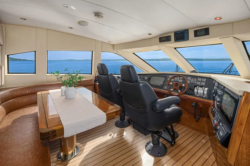 Slide: The Image of Luxurious interior of 2001 Hatteras 63 Cockpit Motor Yacht with elegant wood finishes. - 7