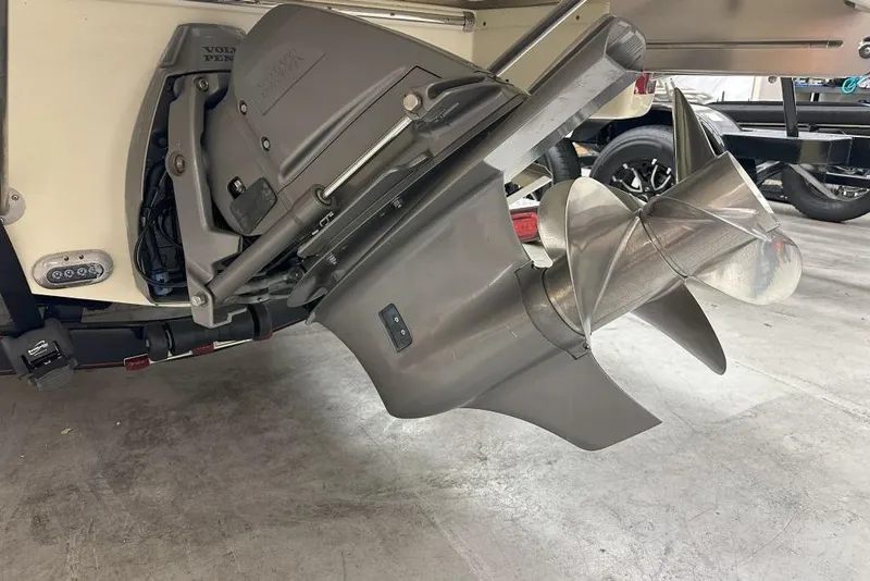 Slide: The Image of 2018 Chris-Craft Launch 27 boat propeller and engine detail in a garage setting. - 10