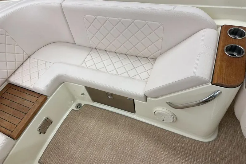 Slide: The Image of 2018 Chris-Craft Launch 27 interior with white quilted seating and wooden accents. - 3