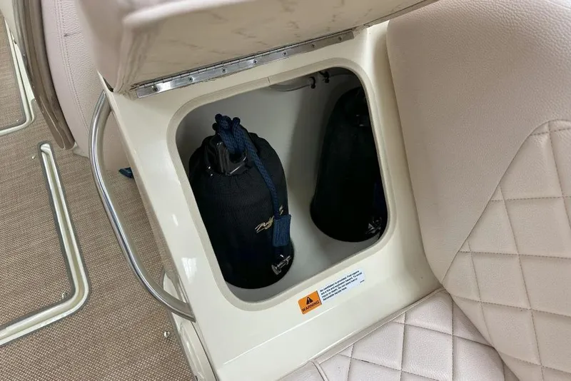 Slide: The Image of Storage compartment in 2018 Chris-Craft Launch 27 boat with fenders inside. - 4