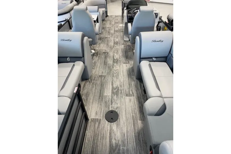 Slide: The Image of Interior of 2026 Bentley Pontoons Legacy 243 Navigator with gray seating and wood-style flooring. - 21