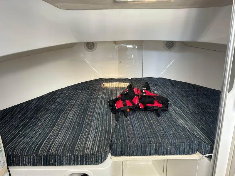 Slide: The Image of Interior cabin of 1982 Robertson 3500 Custom Sportfish with striped bedding and life jacket. - 12