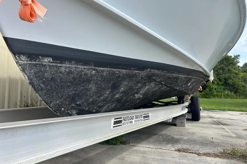 Slide: The Image of 1982 Robertson 3500 Custom Sportfish boat on trailer, showing hull condition. - 19