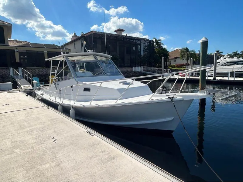 Slide: The Image of 1982 Robertson 3500 Custom Sportfish docked at marina under clear blue sky. - 2
