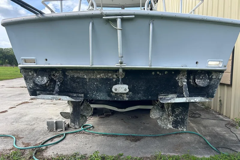 Slide: The Image of 1982 Robertson 3500 Custom Sportfish boat, rear view, showing propellers and hull condition. - 22