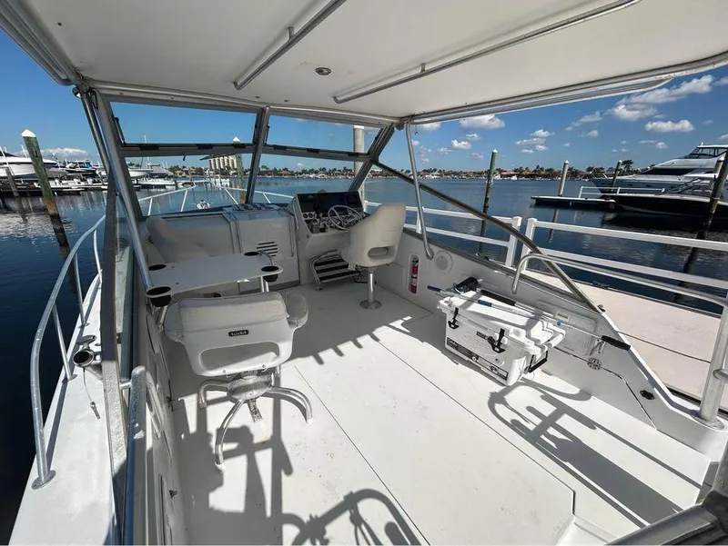 Slide: The Image of 1982 Robertson 3500 Custom Sportfish boat interior with helm, seating, and marina view. - 4