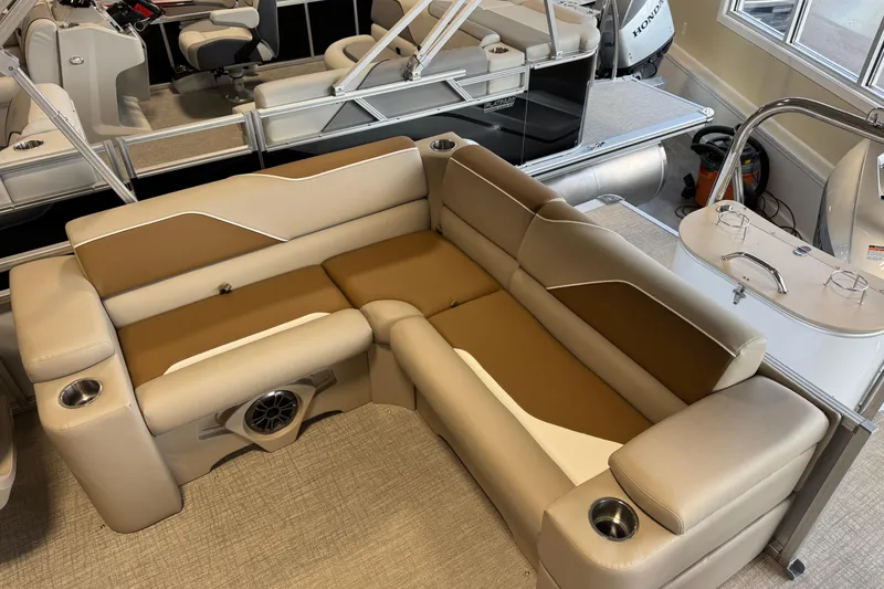Slide: The Image of Luxurious seating on 2026 Avalon Venture 85 ELW pontoon boat, featuring cup holders and premium upholstery. - 10